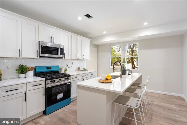 a kitchen with a stove a sink and a microwave