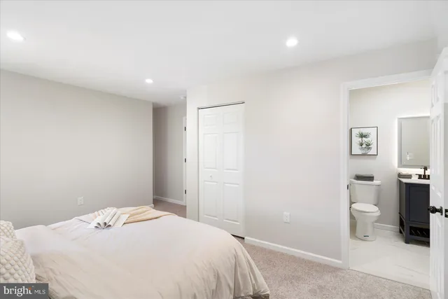 a bedroom with a bed and a view of bathroom