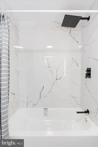 a bathroom with a bathtub and a shower