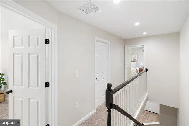 a view of a hallway with wooden floor and entryway
