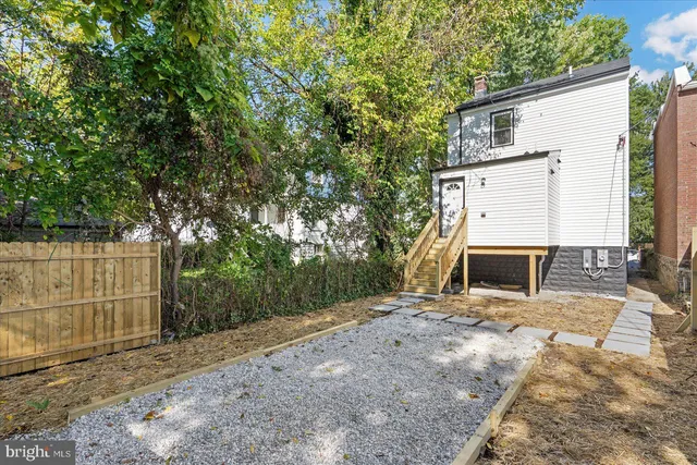 a view of a backyard with a large tree