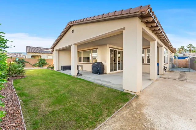a view of a house with backyard and porch