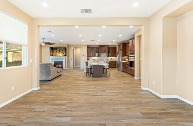 a view of a living room a kitchen and a wooden floor