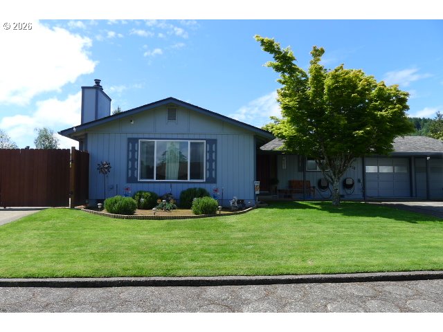 412 Camellia Court Reedsport, OR 97467 - Photo 2 of 48 a front view of a house with a yard