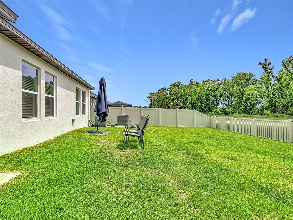 1633 Red Loop Lakeland, FL 33801 - Photo 45 of 60 a view of a backyard with table and chairs and wooden fence