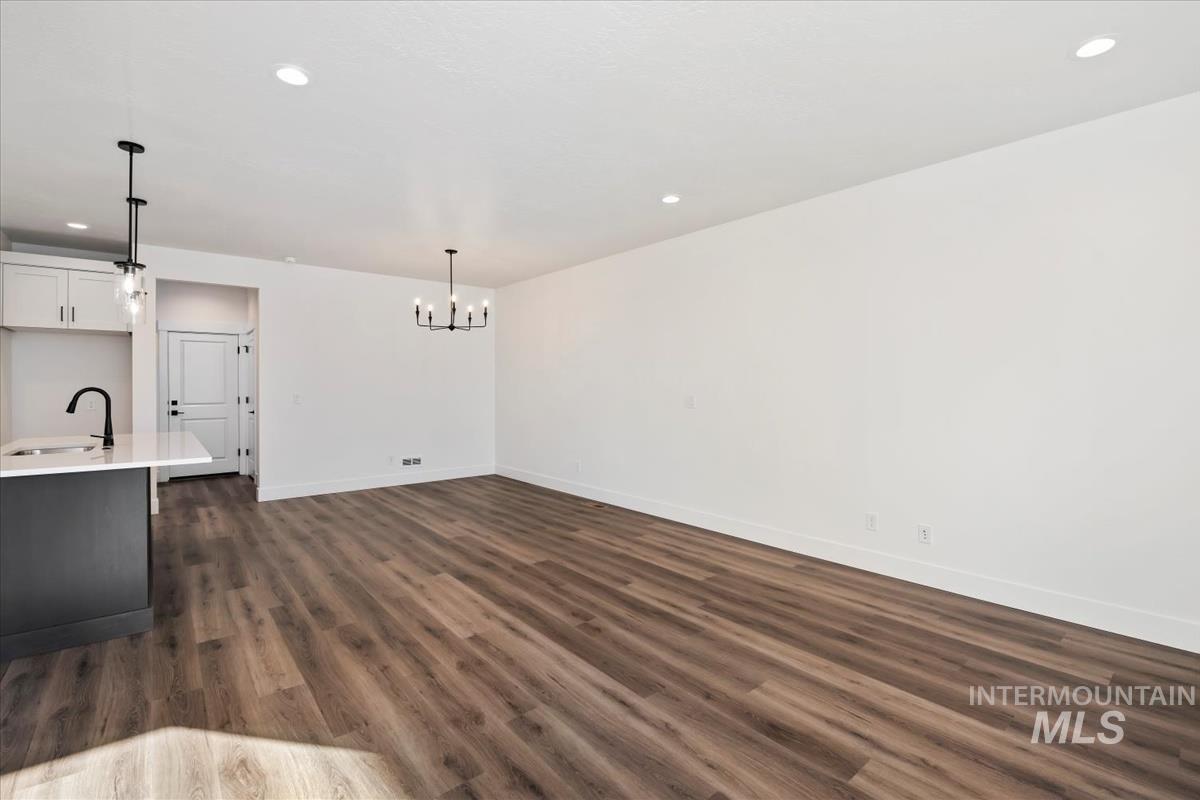 752 South Calhoun Lane Star, ID 83669 - Photo 3 of 45 Open-concept living area featuring wood-finish flooring, recessed lighting, and a modern chandelier