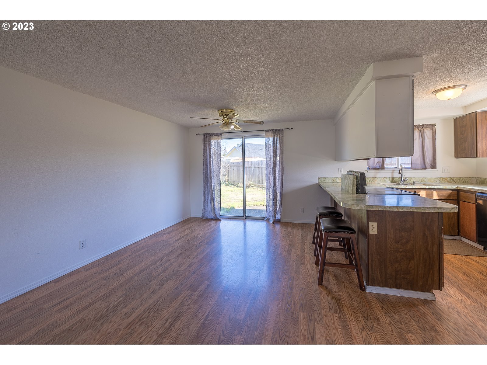 5326 B Street Springfield, OR 97478 - Photo 4 of 18 a workspace with furniture wooden floor and a window