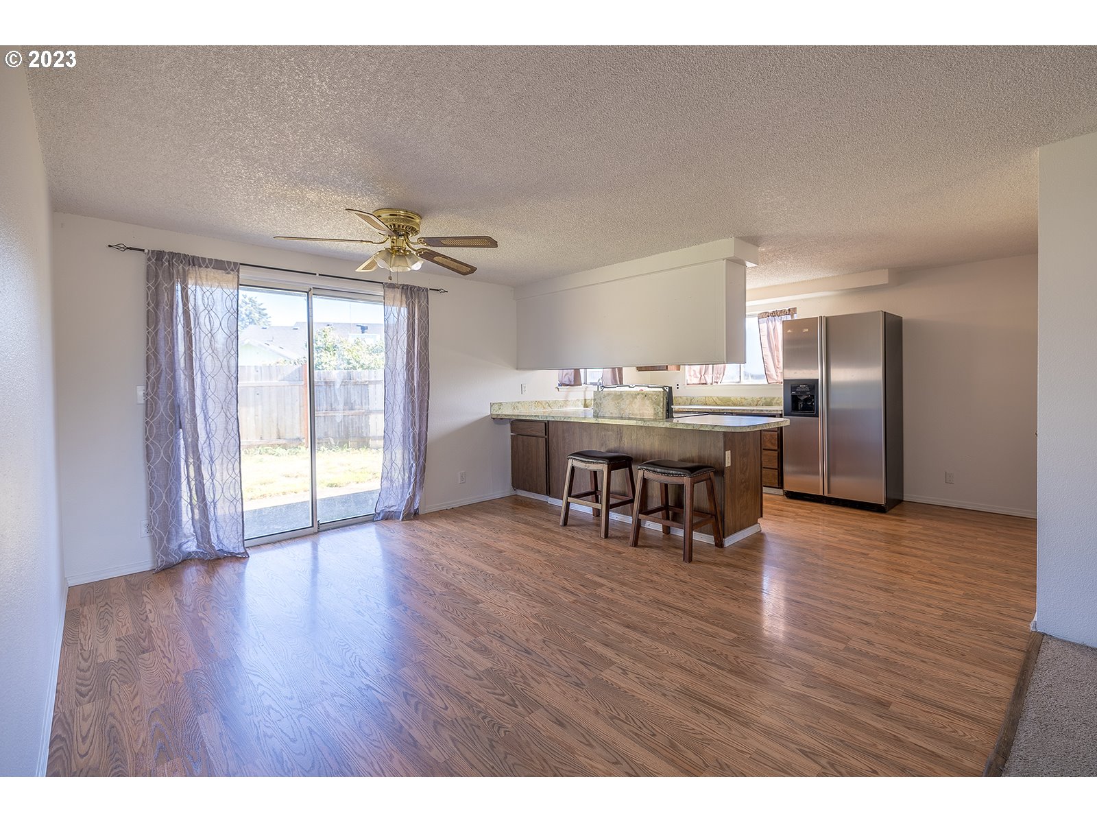 5326 B Street Springfield, OR 97478 - Photo 8 of 18 a view of a dining room with furniture window and wooden floor