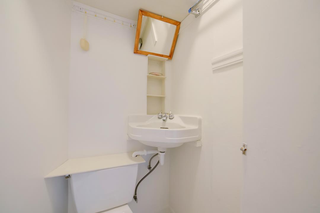 2276 35th Avenue Oakland, CA 94601 - Photo 10 of 32 a bathroom with a sink a mirror and a shower