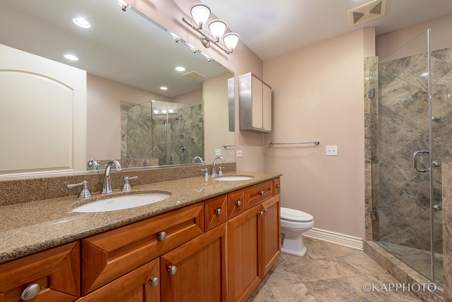 35 South Racine Avenue, Unit 2SE Chicago, IL 60607 - Photo 20 of 27 a bathroom with a granite countertop sink a toilet a mirror and shower