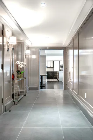 a large kitchen with kitchen island a stove a sink dishwasher and white cabinets with wooden floor