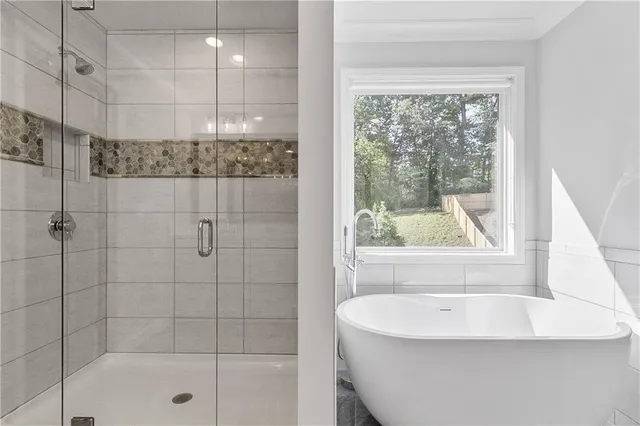 a bathroom with a bathtub and shower