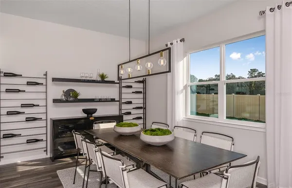 a kitchen with a table chairs and stove