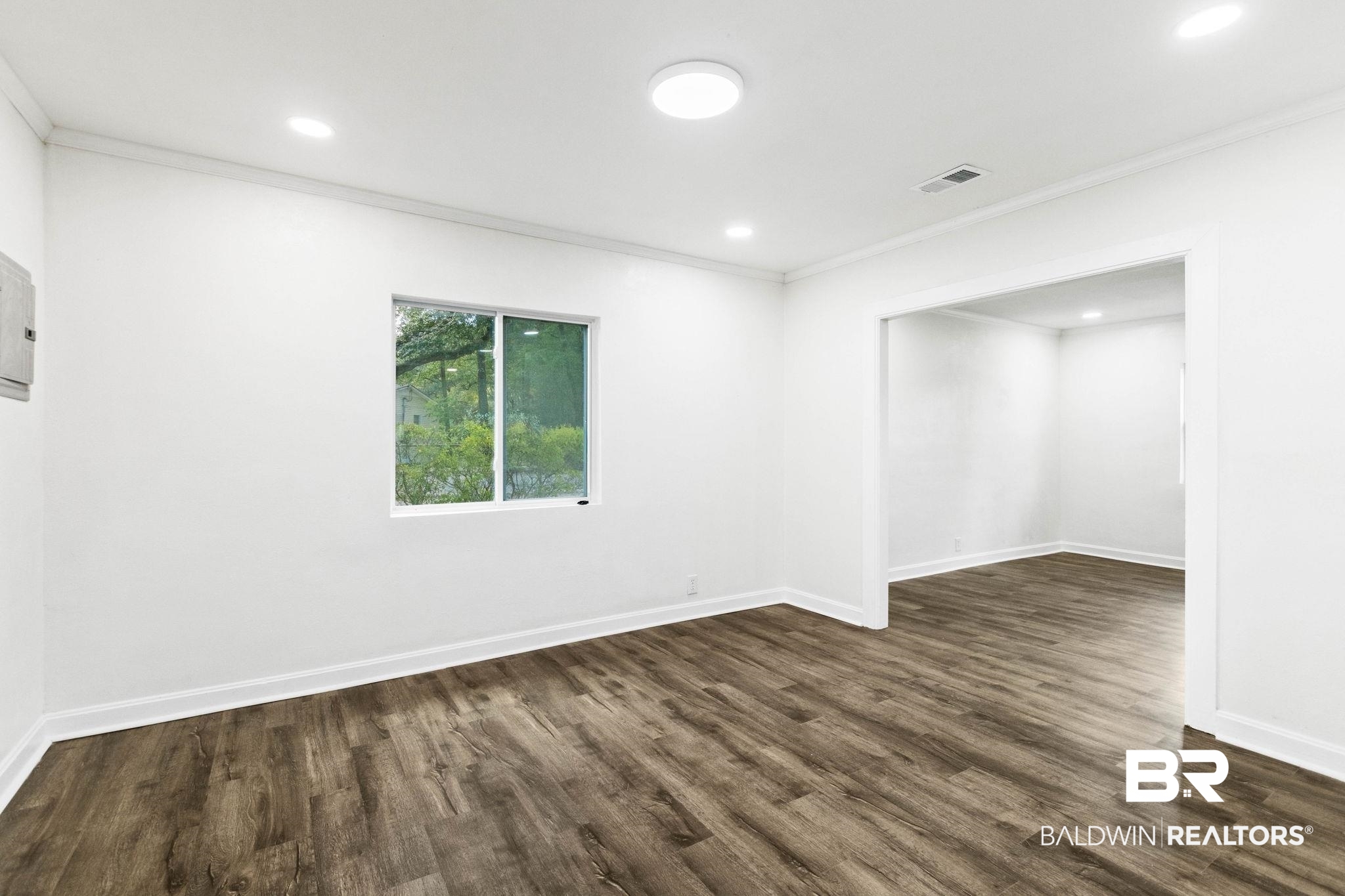 618 Pine Street Saraland, AL 36571 - Photo 15 of 41 Unfurnished room with crown molding, dark wood finished floors, recessed lighting, and electric panel