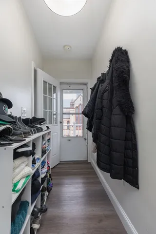 a view of walk in closet with clothes and shoes