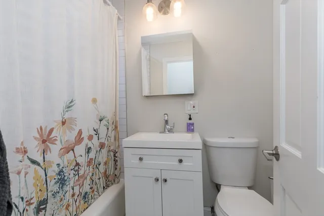 a bathroom with a sink toilet and mirror
