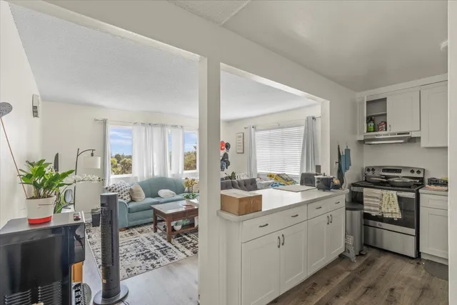 a kitchen with a sink stove and cabinets