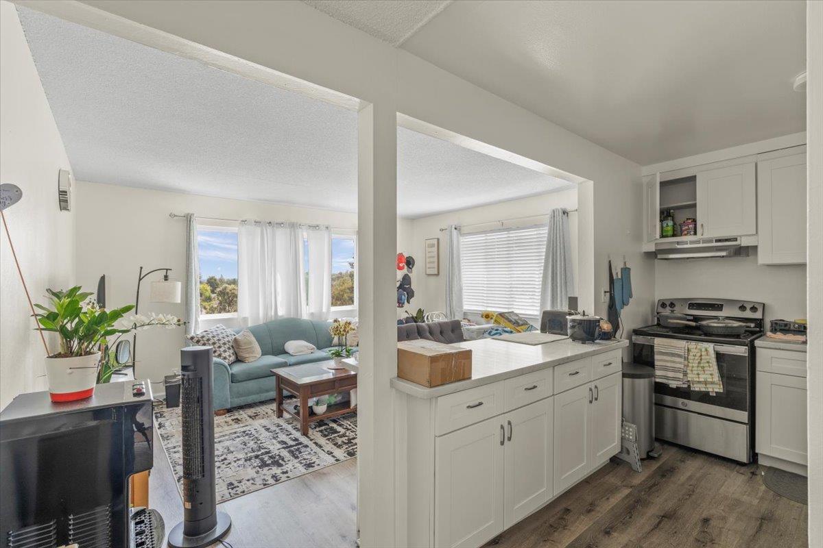 616 Canyon Road Redwood City, CA 94062 - Photo 4 of 11 a kitchen with a sink stove and cabinets