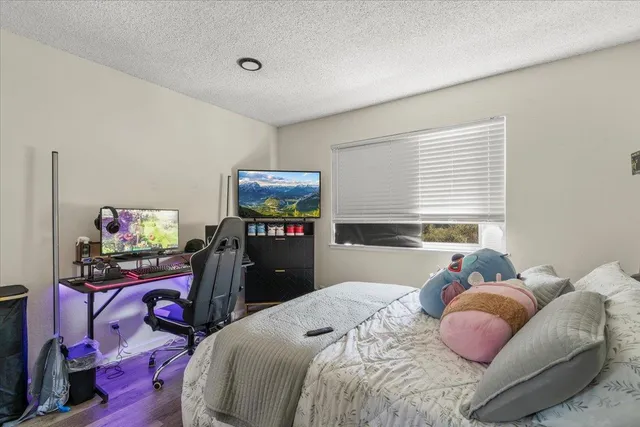 a bedroom with a bed and a tv
