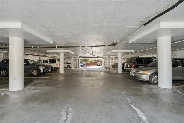 a view of parking garage with cars parked