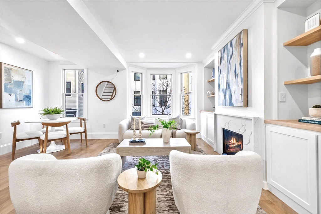 12 Prospect Street, Unit 2 Boston, MA 02129 - Photo 11 of 27 a living room with furniture a fireplace and a large window