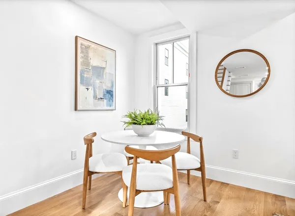 a dining room with furniture and a window
