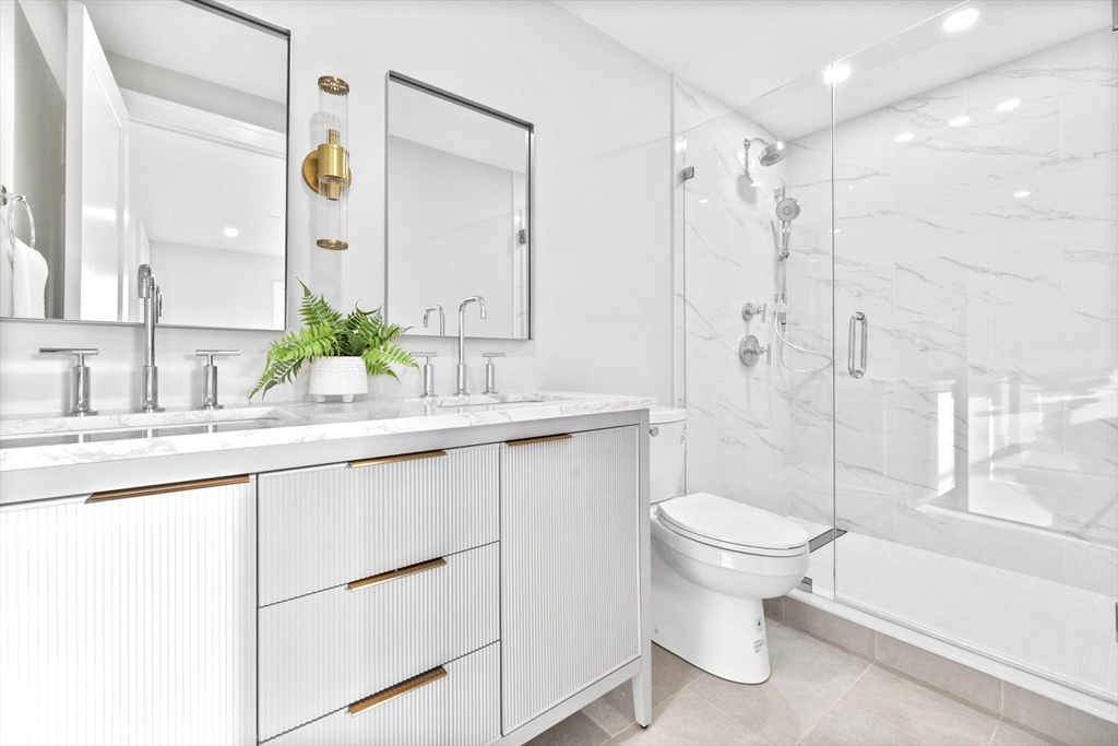 12 Prospect Street, Unit 2 Boston, MA 02129 - Photo 15 of 27 a bathroom with a sink toilet double vanity and shower