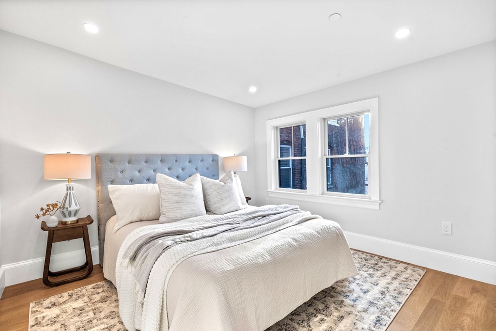 12 Prospect Street, Unit 2 Boston, MA 02129 - Photo 16 of 27 a bedroom with a bed and wooden floor