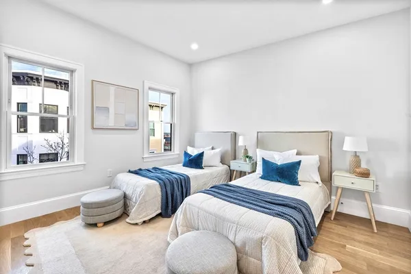 a bedroom with two beds and a window