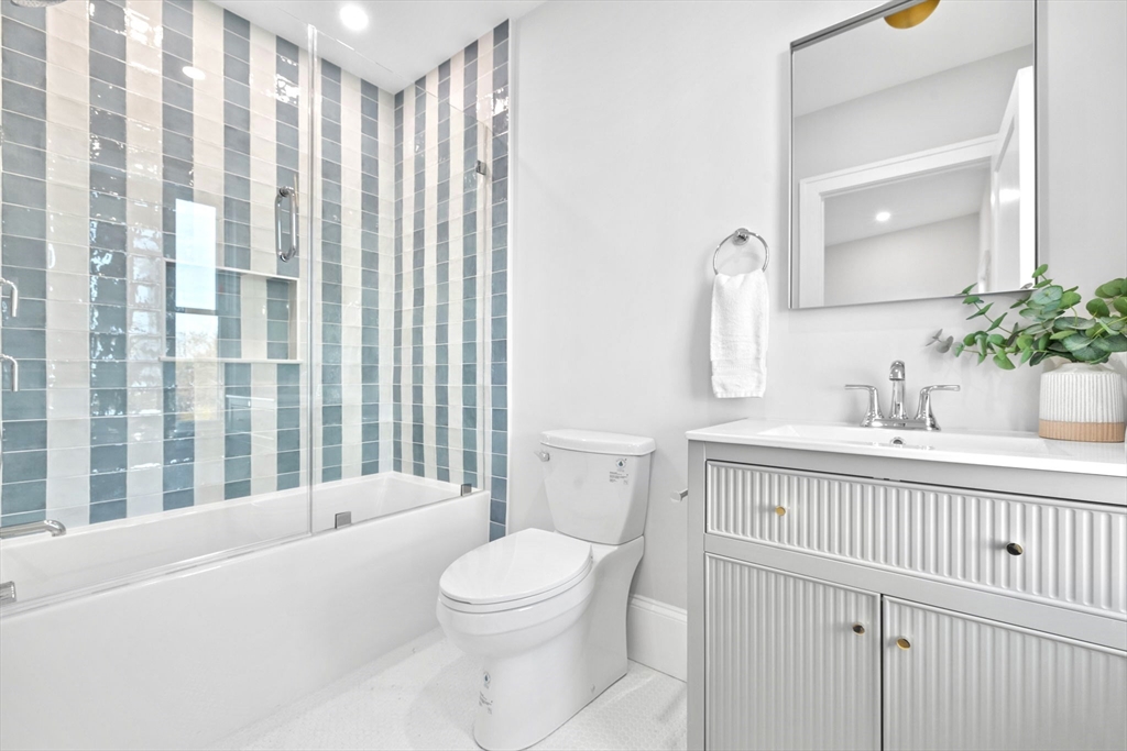 12 Prospect Street, Unit 2 Boston, MA 02129 - Photo 19 of 27 a bathroom with a sink a toilet a mirror and shower