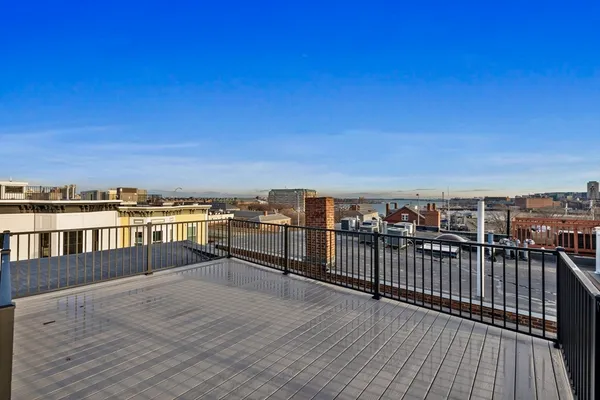 a view of roof deck with two chairs and wooden floor