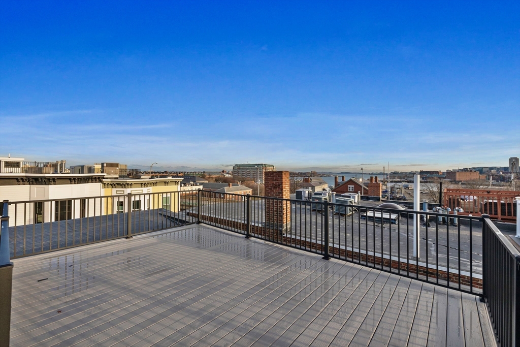 12 Prospect Street, Unit 2 Boston, MA 02129 - Photo 22 of 27 a view of roof deck with two chairs and wooden floor