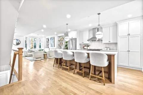 a large kitchen with a table and chairs