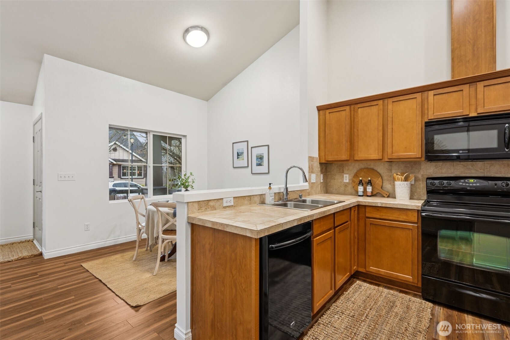 6509 Indiana Street Southeast Olympia, WA 98513 - Photo 11 of 24 a kitchen with a sink stove and wooden floor