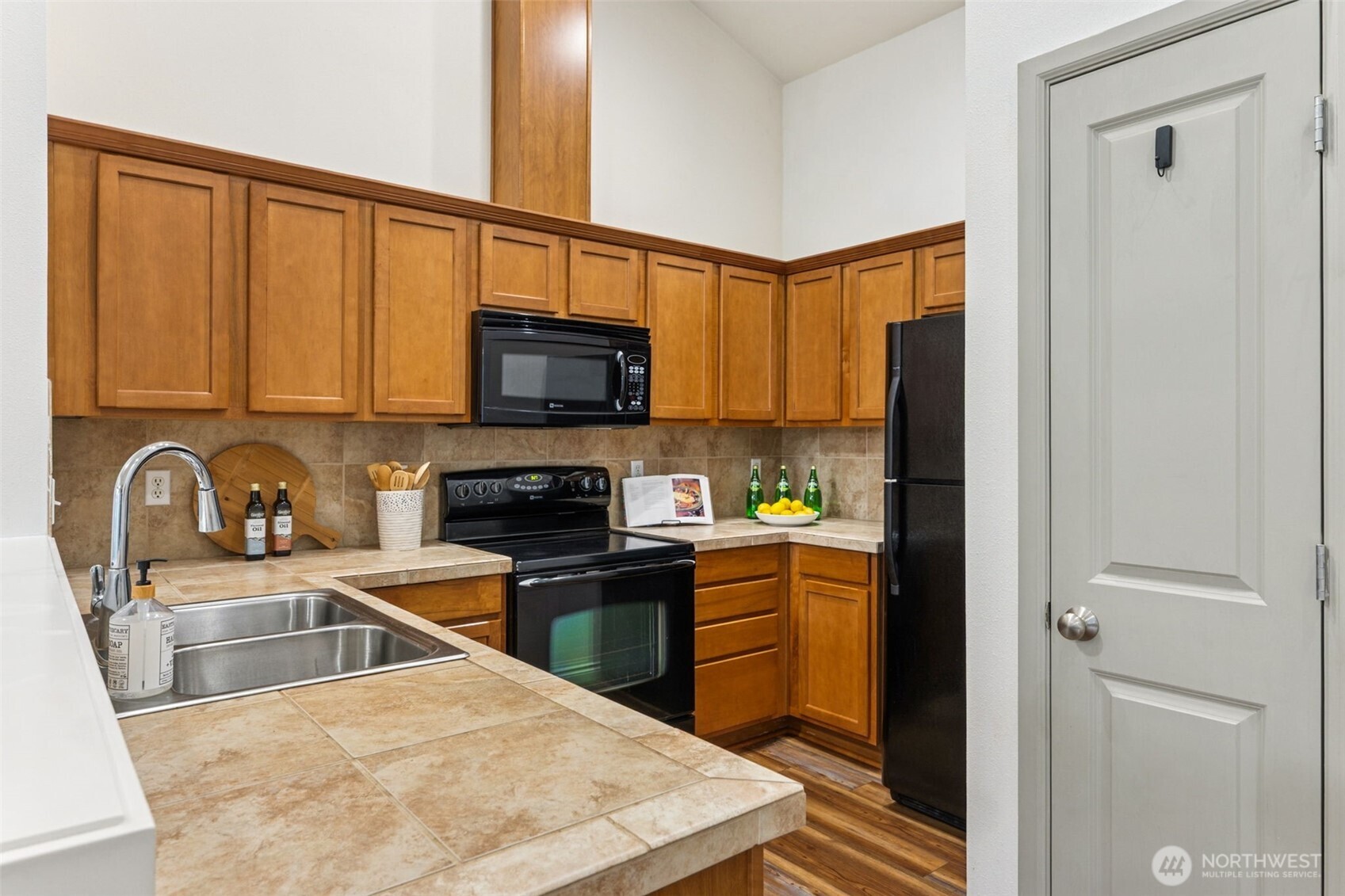 6509 Indiana Street Southeast Olympia, WA 98513 - Photo 12 of 24 a kitchen with stainless steel appliances granite countertop a refrigerator a sink a stove top oven and a cabinets