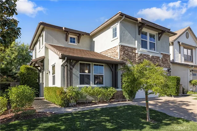 a view of a dining room with furniture a chandelier and wooden floor