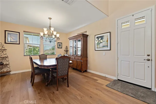 a view of a dining room with furniture and chandelier