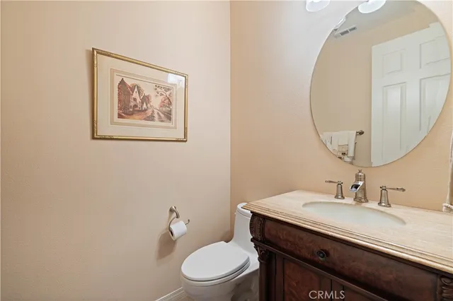 a bathroom with a double vanity sink mirror and toilet