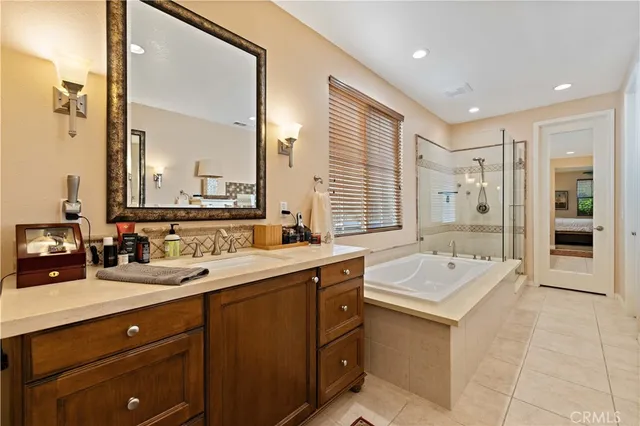 a spacious bedroom with a bed and a chandelier