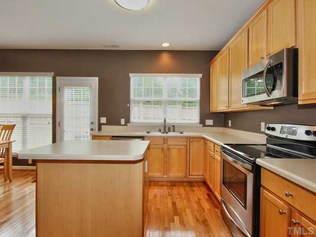 7404 Lagrange Drive Raleigh, NC 27613 - Photo 6 of 25 Your kitchen has tons of cabinets, hardwoods & upgraded plumbing fixtures.
