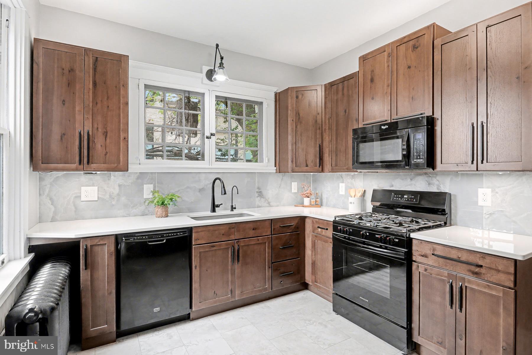 16 West Liberty Street Lancaster, PA 17603 - Photo 19 of 55 a kitchen with stainless steel appliances a stove sink microwave and cabinets