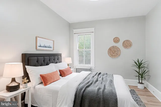 a bedroom with a bed and a lamp