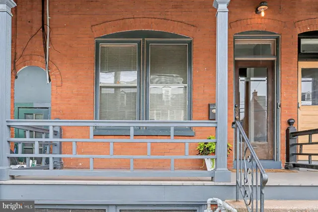 a living room with furniture a rug and a window