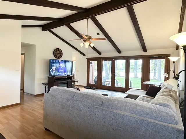 a living room with furniture and a chandelier