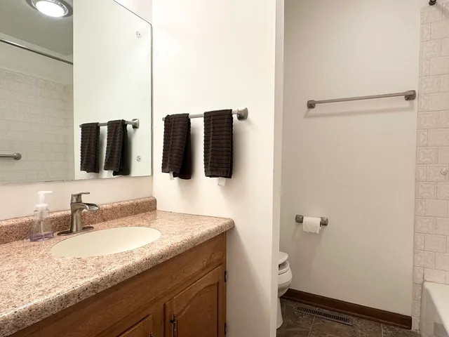 a bedroom with a bed and a night stand