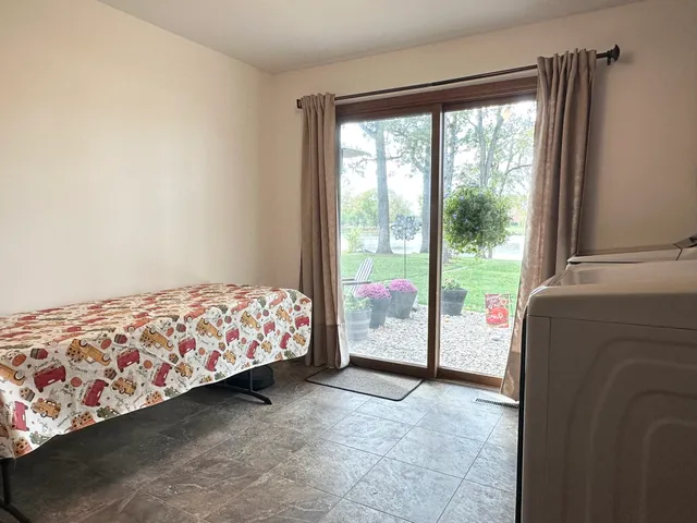 a backyard of a house with barbeque oven table and chairs