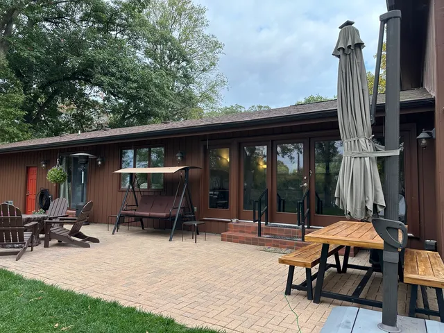 a view of a yard in front of a house with large trees