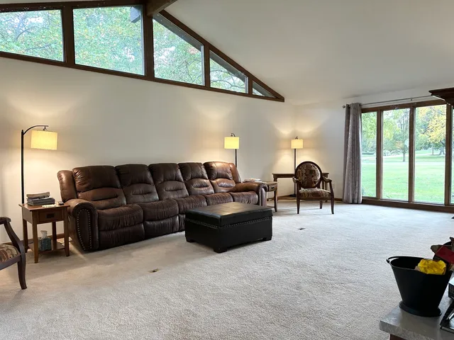 a living room with furniture plant and a large window
