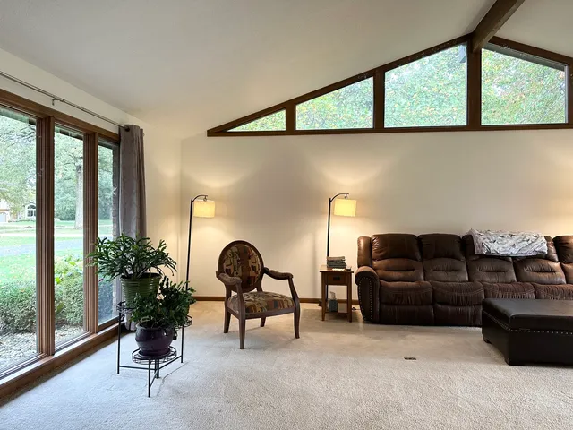 a living room with furniture and large windows