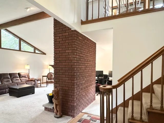 a view of a livingroom with workspace and a window